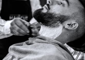 Barber shaves a client