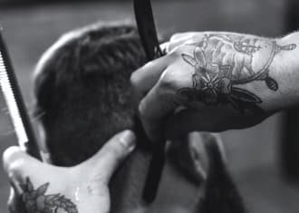 Barber cuts the client's hair