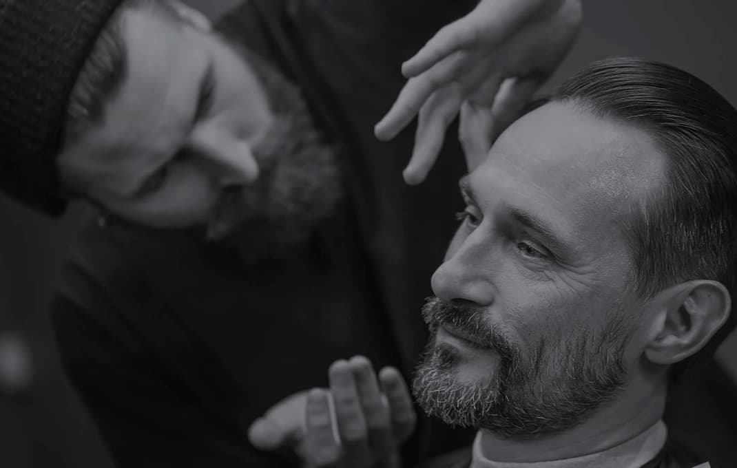 Barber shaves a client