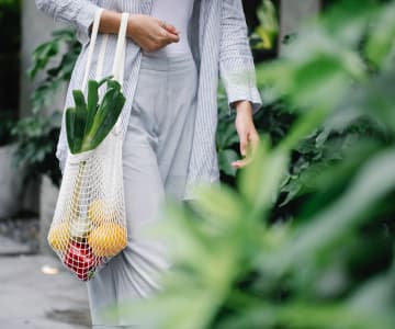 Woman carrying a bag of vegetables
